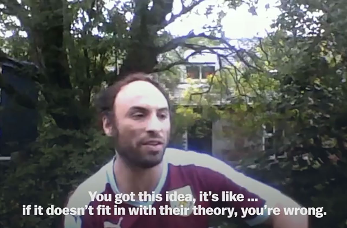 Zach walks across a brige over a roaring river