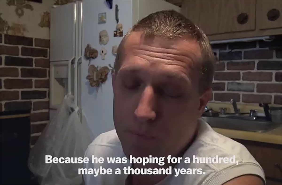 Zach walks across a brige over a roaring river