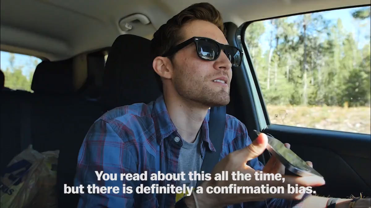 Zach walks across a brige over a roaring river